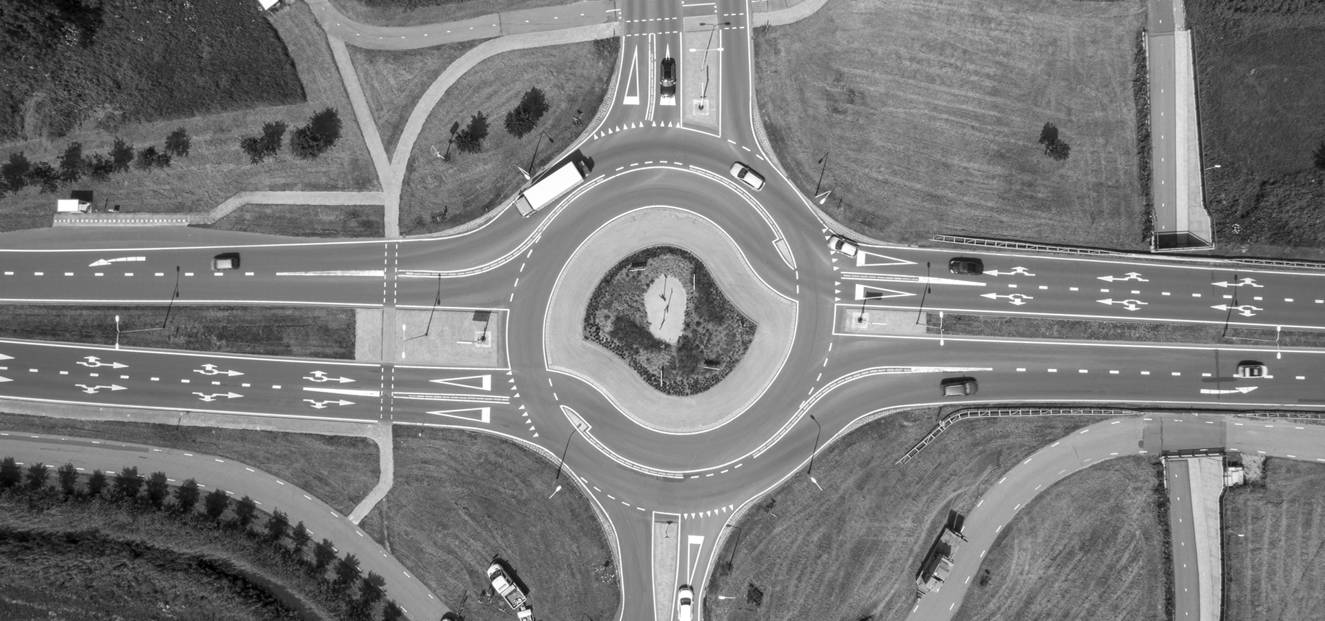 top down aerial view of a traffic roundabout on a main road